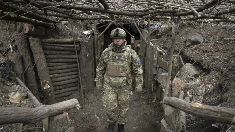 FILE - A Ukrainian serviceman of the 28th Separate Mechanised Brigade stands in a trench at the front line, near Bakhmut, Donetsk region, Ukraine, March 3, 2024. (AP Photo/Efrem Lukatsky, File)