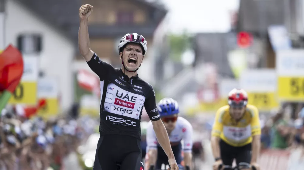 Joao Almeida of Portugal wins the seventh stage, a 207 km race from Neuhausen am Rheinfall to Emmetten, at the 88th Tour de Suisse UCI World Tour cycling race, Saturday, June 21, 2025. (Gian Ehrenzeller/Keystone via AP)