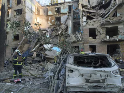 Firefighters work in a destroyed apartment building after a Russian attack in Kyiv, Ukraine, early Monday, June 23, 2025. (AP Photo/Efrem Lukatsky)