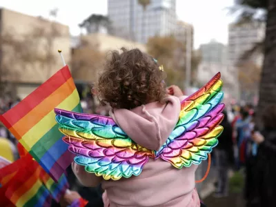 A girl wears rainbow colored wings during the LGBTQ+ Pride parade in Santiago, Chile, June 21, 2025. REUTERS/Pablo Sanhueza