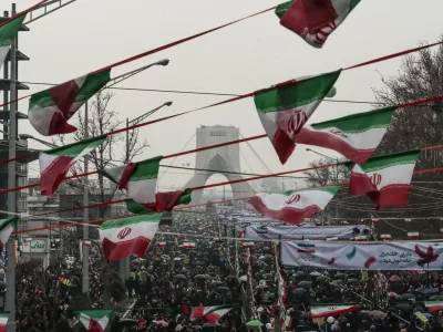 ﻿11 February 2019, Iran, Tehran: People gather in front of the Azadi Tower at the Azadi Square during a ceremony marking the 40th anniversary of the Iranian Islamic Revolution. Photo: Saeid Zareian/dpa