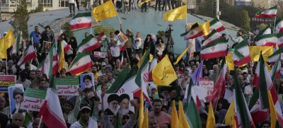 Iranian protesters wave their country's flags and banners containing slogans in support of Supreme Leader Ayatollah Ali Khamenei in an anti-U.S. and anti-Israeli rally at Enqelab-e-Eslami (Islamic Revolution) square in downtown Tehran, Iran, Tuesday, June 24, 2025. (AP Photo/Vahid Salemi)