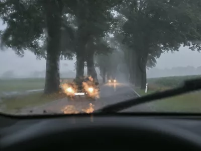 dpatop - 12 July 2024, Brandenburg, Sieversdorf: Heavy rainfall obstructs traffic on an avenue in the Oder-Spree district in eastern Brandenburg. The weekend in Brandenburg gets off to an uncomfortable start with thunderstorms and heavy rain. The German Weather Service (DWD) warns of local rainfall of up to 80 liters per square meter within a few hours. Photo by: Patrick Pleul/picture-alliance/dpa/AP Images