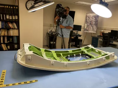 FILE PHOTO: A member of the news media views the Alaska Airlines Flight 1282 door plug in advance of National Transportation Safety Board hearings in early August on the January Alaska Airlines Boeing 737 MAX 9 in-flight door plug emergency, at the NTSB materials lab in Washington, U.S., July 30, 2024. REUTERS/David Shepardson/File Photo