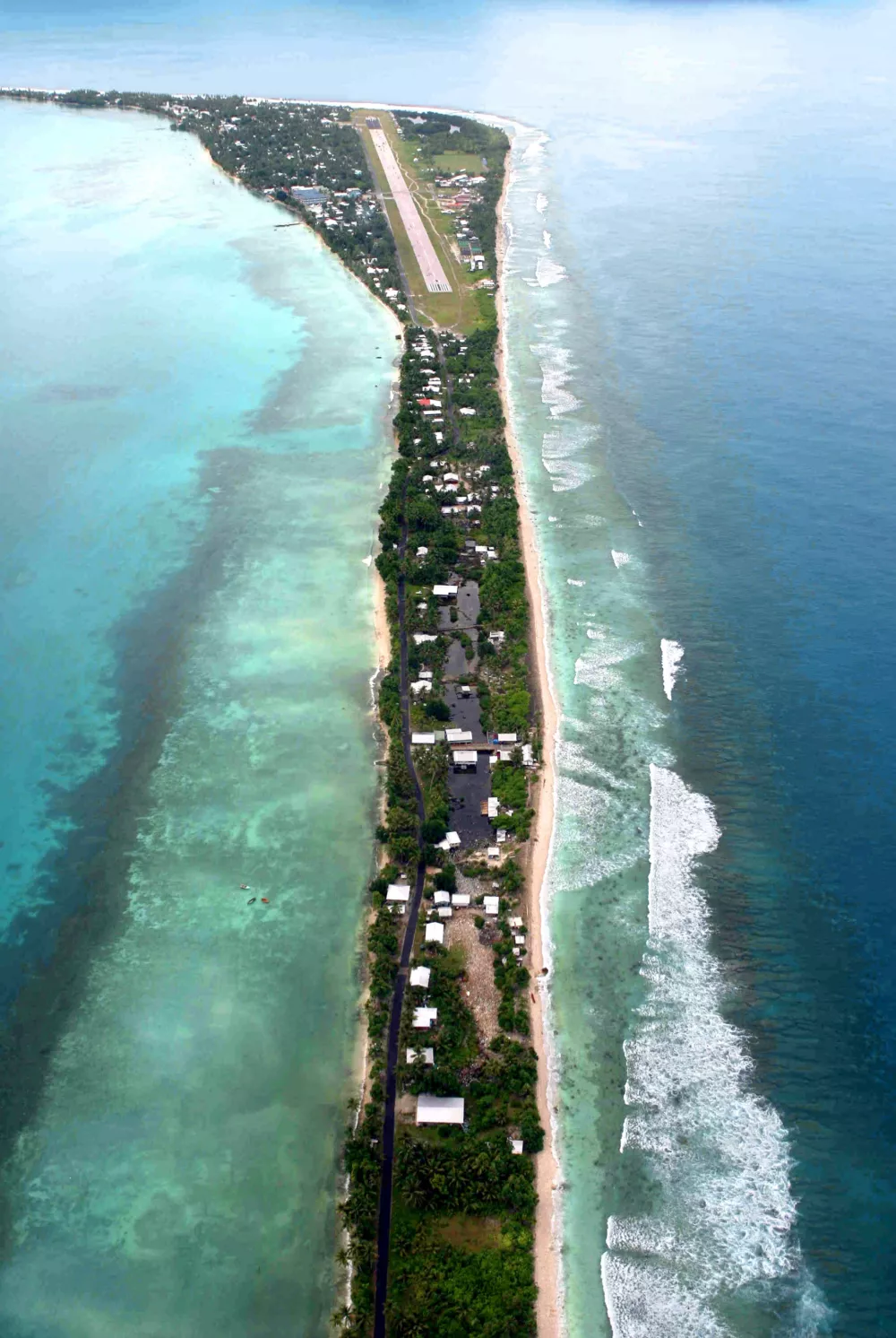 This is an aerial view taken Saturday, March 17, 2007, showing Tuvalu's capital Funafuti, a South Pacific island nation. In this season, the sea level goes up at its highest. And, because of the global warming, white ocean waves approaches closely to the residential area on the narrow atoll city at high tide. (AP Photo/Asahi Shimbun, Soichiro Yamamoto) ** JAPAN OUT NO SALES ONLINE OUT MANDATORY CREDIT **