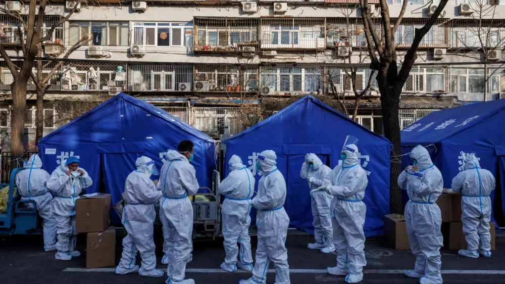 Pandemic prevention workers gather before their shift to look after buildings where residents do home quarantine, as coronavirus disease (COVID-19) outbreaks continue in Beijing, December 8, 2022. REUTERS/Thomas Peter   TPX IMAGES OF THE DAY