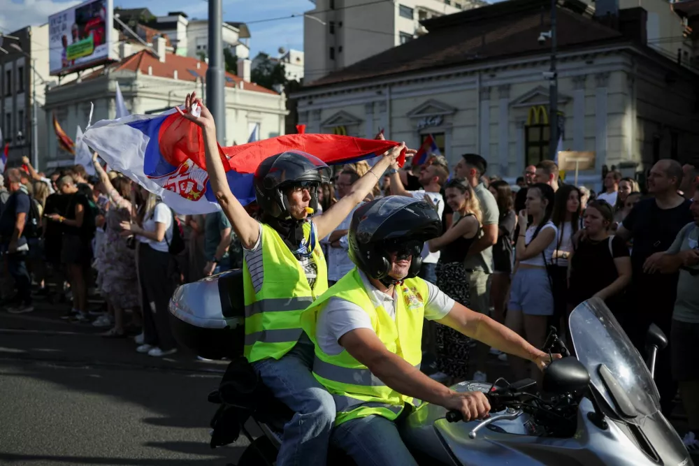 A demonstrator holds a Serbian flag on the back of a motorcycle during an anti-government protest demanding snap elections, at the Slavija square, in Belgrade, Serbia, June 28, 2025. REUTERS/Marko Djurica