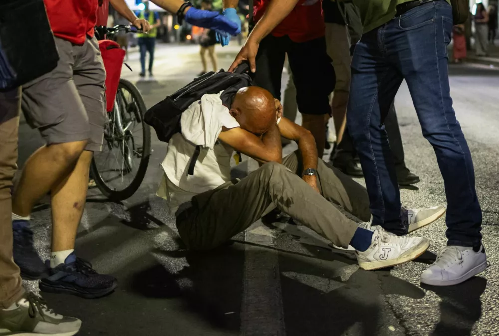 An injured demonstrator is helped during an anti-government protest demanding snap elections, in Belgrade, Serbia, June 28, 2025. REUTERS/Marko Djurica