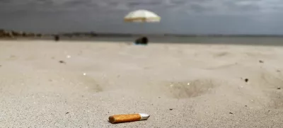 A discarded cigarette butt lies on the sand of La Baule beach on the Atlantic coast, as a nationwide ban on smoking is due to come into effect on July 1, at beaches, parks and outside schools to protect children, France, June 25, 2025. REUTERS/Stephane Mahe