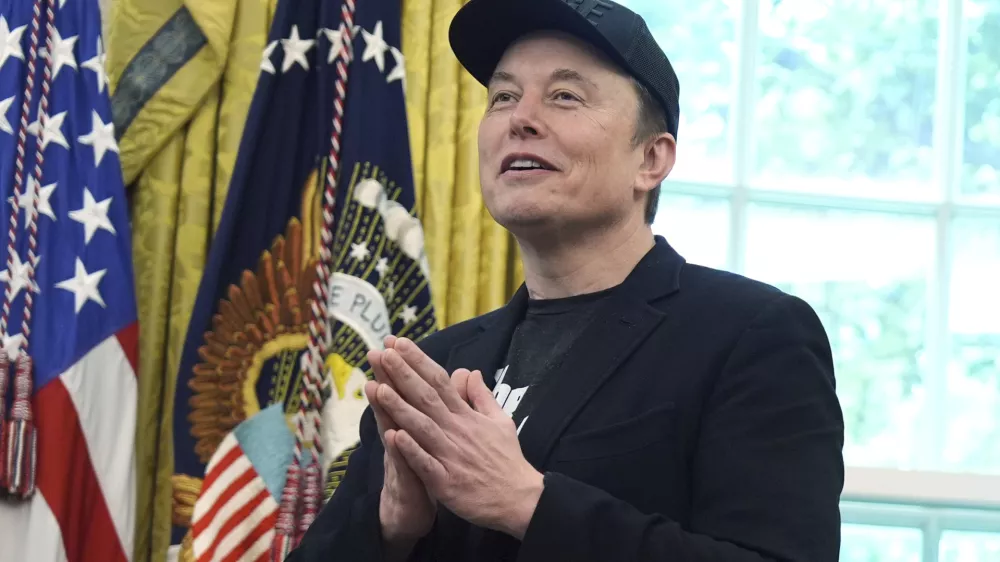 Elon Musk gestures as he speaks during a news conference with President Donald Trump in the Oval Office of the White House, Friday, May 30, 2025, in Washington. (AP Photo/Evan Vucci)