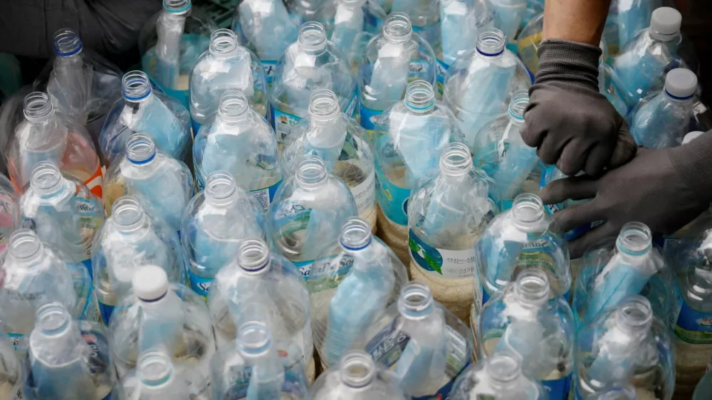 FILE PHOTO: Members of North Korean defector group Kuensaem fill empty plastic bottles with rice and masks, during preparations for an event to send the bottles towards the North, in Seoul, South Korea, June 18, 2020. REUTERS/Kim Hong-Ji/File Photo