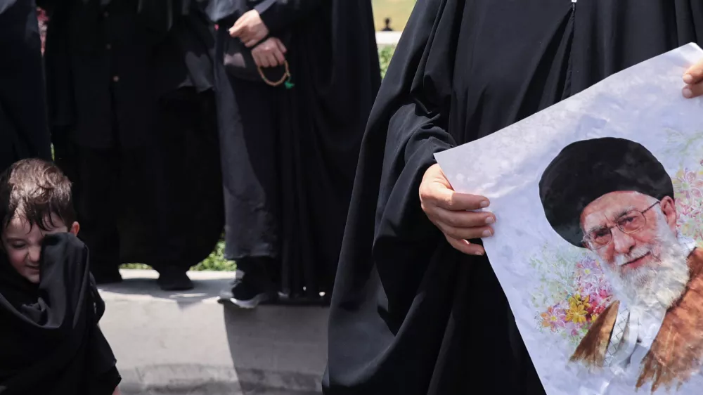 A woman holds a picture of Iran's Supreme Leader Ayatollah Ali Khamenei as she attends the funeral procession of Iranian military commanders and nuclear scientists killed in Israeli strikes, in Tehran, Iran, June 28, 2025. Majid Asgaripour/WANA (West Asia News Agency) via REUTERS  ATTENTION EDITORS - THIS PICTURE WAS PROVIDED BY A THIRD PARTY