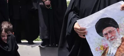 A woman holds a picture of Iran's Supreme Leader Ayatollah Ali Khamenei as she attends the funeral procession of Iranian military commanders and nuclear scientists killed in Israeli strikes, in Tehran, Iran, June 28, 2025. Majid Asgaripour/WANA (West Asia News Agency) via REUTERS  ATTENTION EDITORS - THIS PICTURE WAS PROVIDED BY A THIRD PARTY