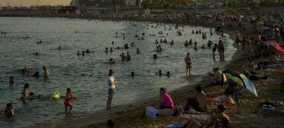 Swimmers cool off in the water at a beach on a hot day in Barcelona, Spain, Sunday, June 29, 2025. (AP Photo/Emilio Morenatti)