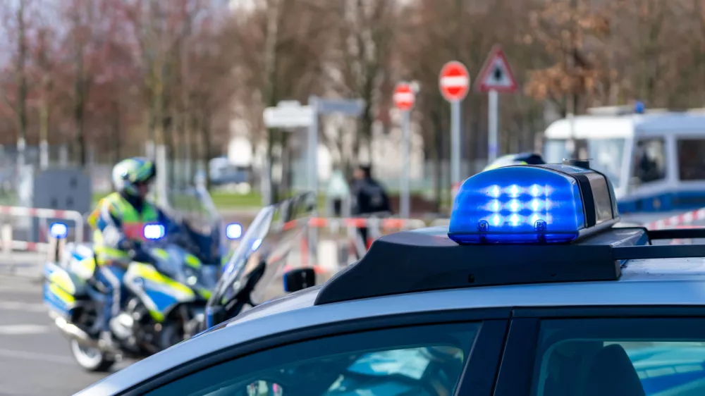 Blue Flash Light Of Police Car Against Police Officers On Motor Bike / Foto: Reinhard Krull