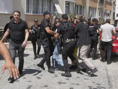 A man is detained by Turkish police officers as he tries to gather with others to celebrate the annual LGBTQ+ Pride March, in Istanbul, Turkey, Sunday, June 29, 2025. (AP Photo/Dilara Acikgoz)