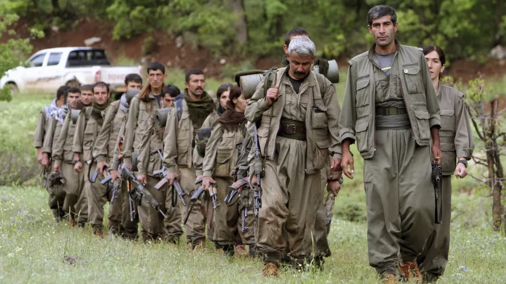 FILE - A group of armed Kurdish fighters from the Kurdistan Workers Party (PKK) enter northern Iraq in the Heror area, northeast of Dahuk, 260 miles (430 kilometers) northwest of Baghdad, Iraq, May 14, 2013. (AP Photo/Ceerwan Aziz, File)