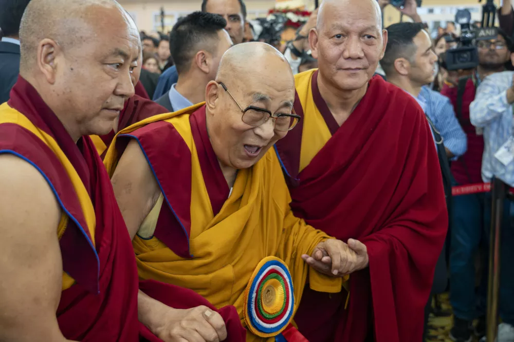 Attendant monks help Tibetan spiritual leader the Dalai Lama to leave after presiding over an event celebrating his 90th birthday according to a Tibetan calendar at the Tsuglakhang temple in Dharamshala, India, Monday, June 30, 2025, ahead of his birthday according to the Gregorian calendar on July 6. (AP Photo/Ashwini Bhatia)