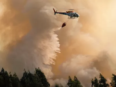﻿A firefighting helicopter drops its load of water on a forest fire near Santa Comba Dao, northern Portugal, Thursday, Aug. 11 2016. Firefighters in Portugal are battling multiple blazes fed by brush in a hot, dry summer for a sixth straight day. Major fires have also been raging in northwestern Spain and southern France. (AP Photo/Sergio Azenha)