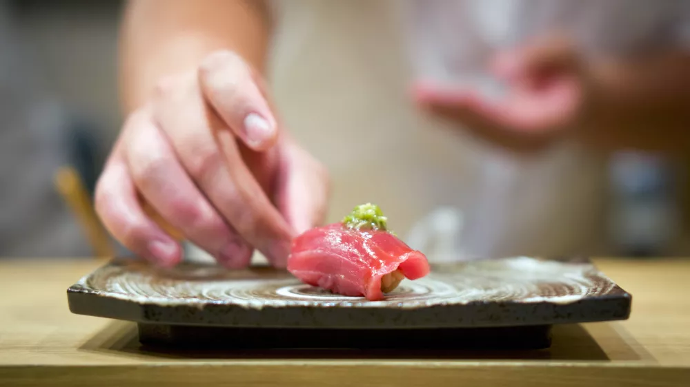 Tuna Sushi with fresh wasabi served on ceramic plate. Enjoy Omakase experience at Japanese Sushi Restaurant.