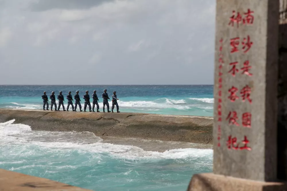 ﻿Soldiers of China's People's Liberation Army (PLA) Navy patrol near a sign in the Spratly Islands, known in China as the Nansha Islands, February 9, 2016. The sign reads "Nansha is our national land, sacred and inviolable." REUTERS/Stringer/File Photo ATTENTION EDITORS - THIS PICTURE WAS PROVIDED BY A THIRD PARTY. THIS PICTURE IS DISTRIBUTED EXACTLY AS RECEIVED BY REUTERS, AS A SERVICE TO CLIENTS. CHINA OUT. NO COMMERCIAL OR EDITORIAL SALES IN CHINA. FROM THE FILES PACKAGE - SEARCH "SOUTH CHINA SEA FILES" FOR ALL IMAGES   TPX IMAGES OF THE DAY