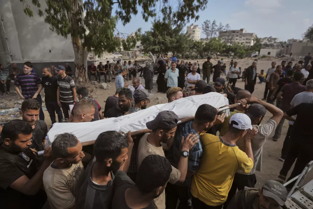 Mourners carry the body of a Palestinian man, who was killed while heading to an aid distribution hub, during his funeral in Gaza City, Thursday, July 3, 2025. (AP Photo/Jehad Alshrafi)`
