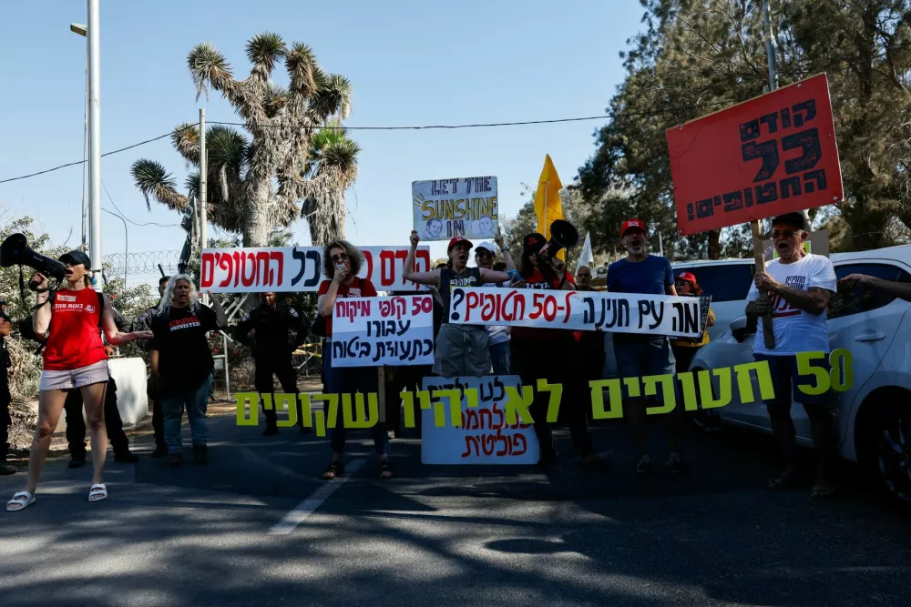 Protestors gather at the entrance to Kibbutz Nir Oz, which is located near the Israel Gaza border and was attacked by Hamas on October 7, 2023, on the day Israel Prime Minister Benjamin Netanyahu visits for the first time since the October 7, 2023 attack, in Nir Oz, Israel July 3, 2025. REUTERS/Amir Cohen