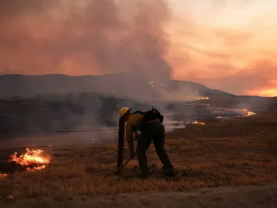 A firefighter works to tackle the Madre Fire near New Cuyama, California, U.S. July 3, 2025. REUTERS/David Swanson