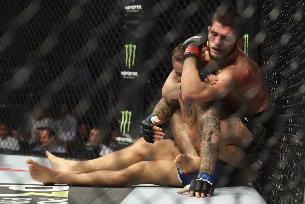﻿Russian UFC fighter Khabib Nurmagomedov, choke holds UFC fighter Dustin Poirier, of Lafayette, La., during Lightweight title mixed martial arts bout at UFC 242, in Yas Mall in Abu Dhabi, United Arab Emirates, Saturday, Sept.7 2019. (AP Photo/ Mahmoud Khaled)