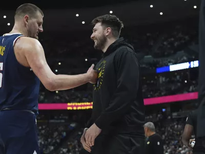 Denver Nuggets center Nikola Jokic, left, greets Los Angeles Lakers guard Luka Doncic, right, in the first half of an NBA basketball game Friday, March 14, 2025, in Denver. (AP Photo/David Zalubowski)