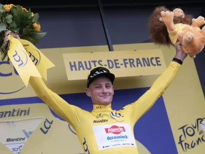 Netherlands' Mathieu van der Poel wearing the overall leader's yellow jersey celebrates on the podium after winning the second stage of the Tour de France cycling race over 209.1 kilometers (129.9 miles) with start in Lauwin-Planque and finish in Boulogne-sur-Mer, France, Sunday, July 6, 2025. (AP Photo/Mosa'ab Elshamy)