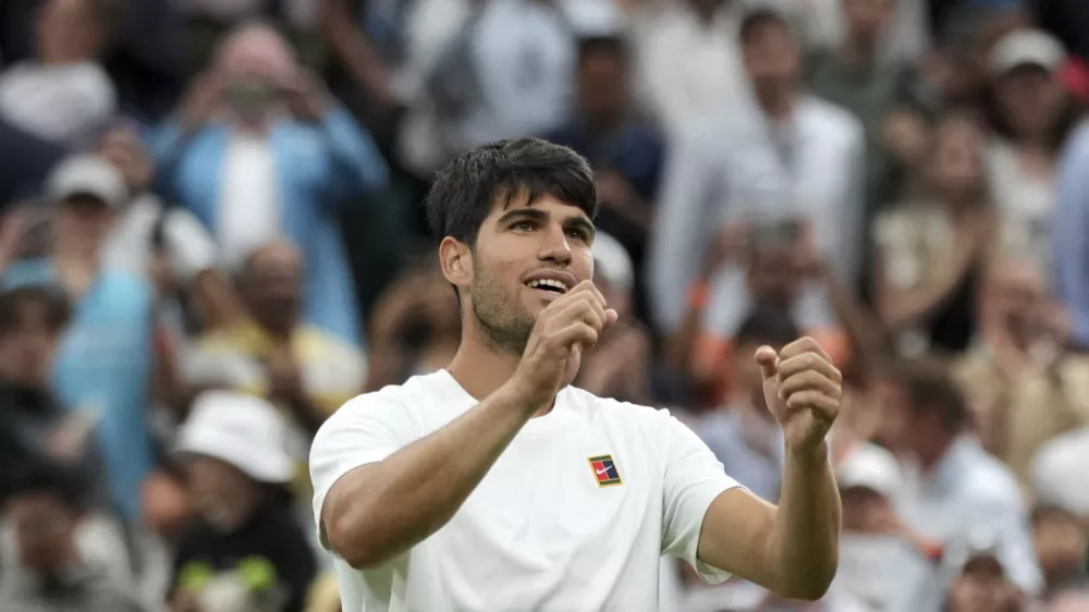 Spain's Carlos Alcaraz celebrates after beating Russia's Andrey Rublev during a fourth round men's singles match at the Wimbledon Tennis Championships in London, Sunday, July 6, 2025. (AP Photo/Alastair Grant)