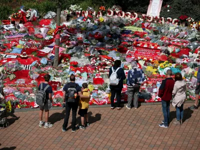Fans pay their respects outside Anfield Stadium, following the death of Liverpool Football Club soccer player Diogo Jota, in Liverpool, Britain, July 7, 2025. REUTERS/Phil Noble