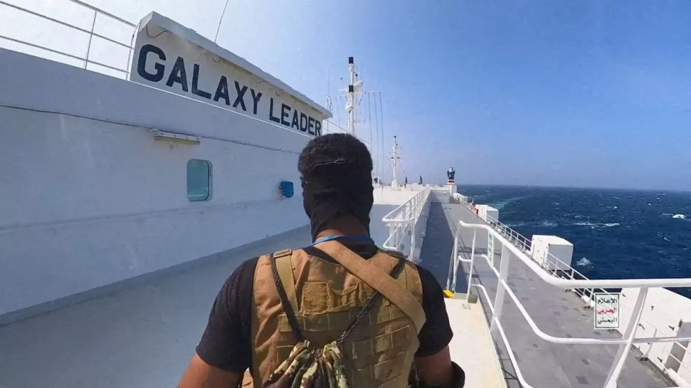 FILE PHOTO: A Houthi fighter stands on the Galaxy Leader cargo ship in the Red Sea in this photo released November 20, 2023. Houthi Military Media/Handout via REUTERS  THIS IMAGE HAS BEEN SUPPLIED BY A THIRD PARTY//File Photo
