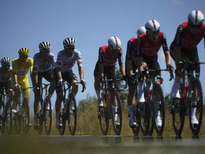 Slovenia's Tadej Pogacar wearing the overall leader's yellow jersey rides in the pack during the sixth stage of the Tour de France cycling race over 201.5 kilometers (125.2 miles) with start in Bayeux and finish in Vire Normandy, France, Thursday, July 10, 2025. (AP Photo/Thibault Camus)