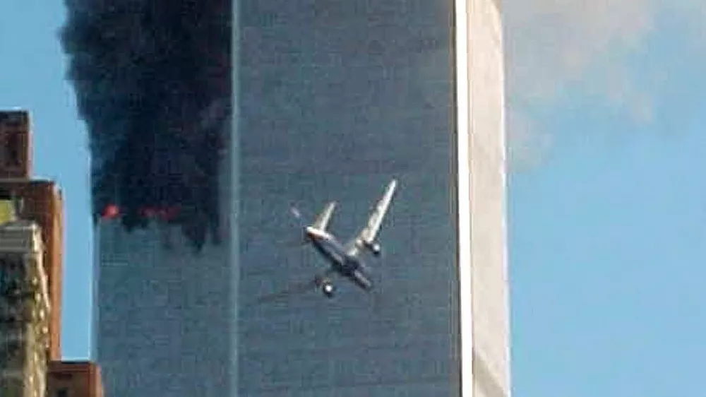 ﻿** ADVANCE FOR TUESDAY, NOV. 4, 2008 AND THEREAFTER ** FILE ** In this Sept. 11, 2001 file photo, a jet airliner nears one of the World Trade Center towers in New York. For all of the candidates' talk about the need for change, Americans have seen plenty of it since the last time they selected a new leader - including the attack on the World trade Center in 2001. (AP Photo/Carmen Taylor/File)