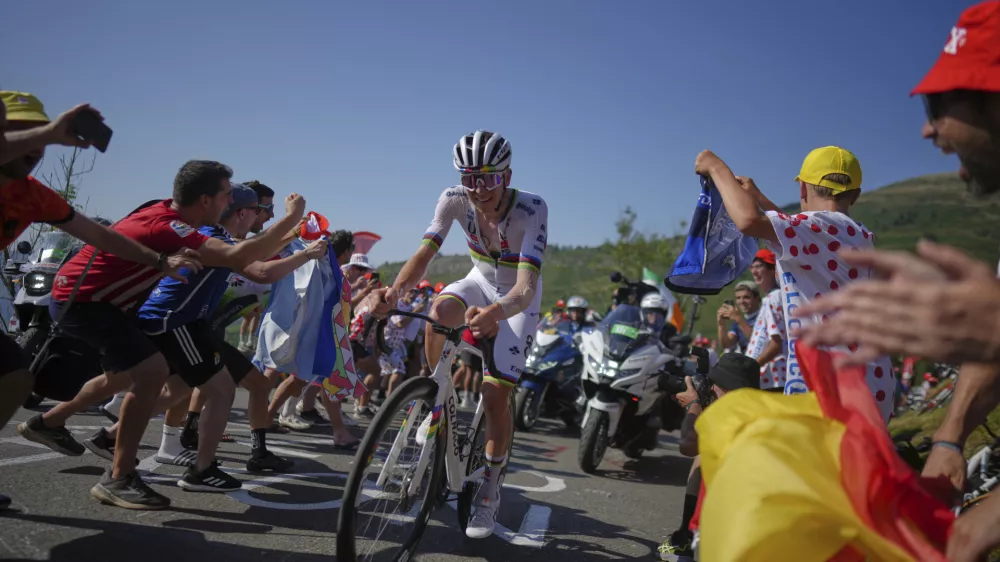 Slovenia's Tadej Pogacar climbs towards Hautacom to win the twelfth stage of the Tour de France cycling race over 180.6 kilometers (112.2 miles) with start in Auch and finish in Hautacam, France, Thursday, July 17, 2025. (AP Photo/Thibault Camus)