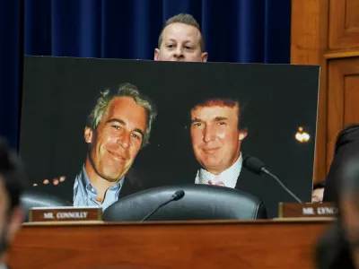 Rep. Jared Moskowitz (D-FL) holds up a photo of former U.S. President Donald Trump with late sex offender Jeffrey Epstein during a meeting of the the House Oversight and Accountability Committee to markup a resolution and report to hold Hunter Biden, President Joe Biden's son, in contempt of Congress, after he refused to appear for a closed-door deposition, at the Capitol in Washington, U.S., January 10, 2024. REUTERS/Kevin Lamarque