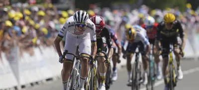 Slovenia's Tadej Pogacar sprints to the finish line to win the seventh stage of the Tour de France cycling race over 197 kilometers (122.4 miles) with start in Saint-Malo and finish in Mur-de-Bretagne Guerledan, France, Friday, July 11, 2025. (AP Photo/Thibault Camus)