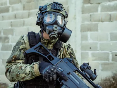 Soldier in cropat uniform with protective gas mask M95 and assault rifle G36, caliber 5.56x45.