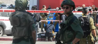 Israeli security personnel stand guard near the scene of a stabbing attack, in Gush Etzion in the Israeli-occupied West Bank July 10,2025. REUTERS/Ammar Awad