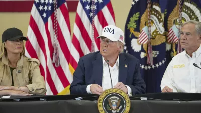President Donald J. Trump, center, first lady Melania Trump and Texas Gov. Greg Abbott, attend a roundtable discussion at the Community Emergency Operations Center in Kerrville, Texas, Friday, July 11, 2025. (Ricardo B. Brazziell/Austin American-Statesman via AP)