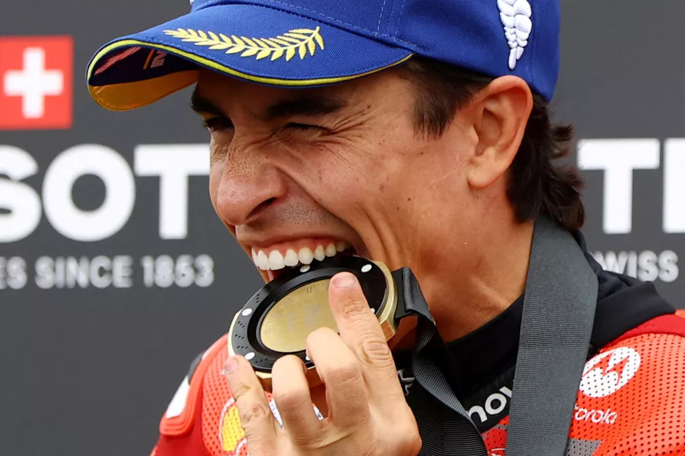 MotoGP - German Grand Prix - Sachsenring, Hohenstein-Ernstthal, Germany - July 12, 2025 Ducati Lenovo Team's Marc Marquez celebrates with his medal after winning the sprint race REUTERS/Lisi Niesner   TPX IMAGES OF THE DAY