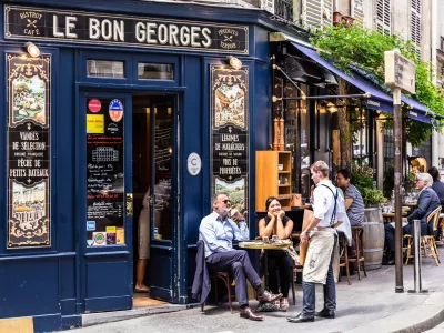 Paris, France - June 16, 2017: The charming Cafe Le Bon Georges. Parisians and tourists enjoy food and drinks at the street french cafe.