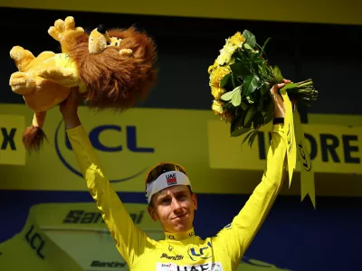 Cycling - Tour de France - Stage 9 - Chinon to Chateauroux - Chinon, France - July 13, 2025 UAE Team Emirates XRG's Tadej Pogacar celebrates on the podium wearing the yellow jersey after stage 9 REUTERS/Sarah Meyssonnier