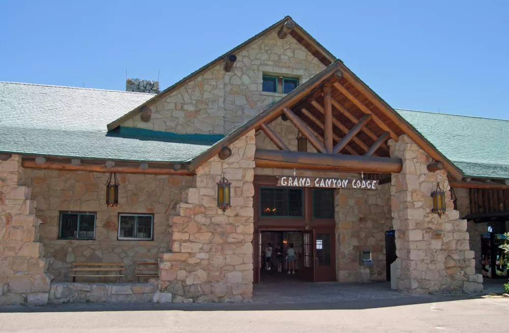 This undated photo provided by the National Park Service shows the historic Grand Canyon Lodge's front entrance with a sloped roof, huge ponderosa beams and massive limestone facade, on the North Rim of Grand Canyon, in northern Arizona. (Michael Quinn/National Park Service via AP)