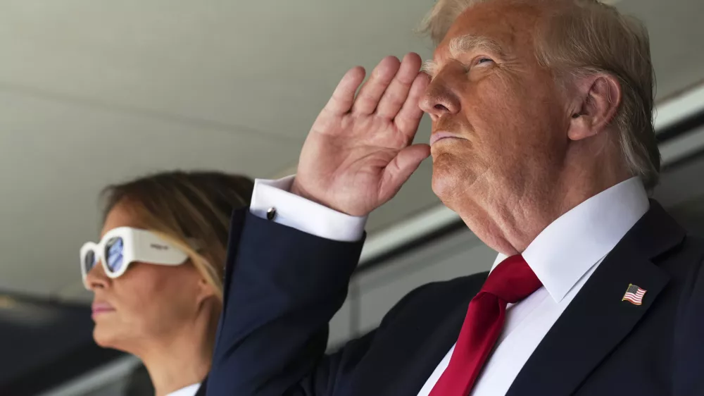 President Donald Trump, right, salutes alonside first lady Melania Trump as they attend the Club World Cup final soccer match, at MetLife Stadium in East Rutherford, N.J., Sunday, July 13, 2025. (AP Photo/Jacquelyn Martin)