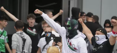 Supporters of Polish far-right Confederation party and soccer hooligans take part in a anti-immigration demonstration in Warsaw Saturday, July 19, 2025. (AP Photo/Czarek Sokolowski)