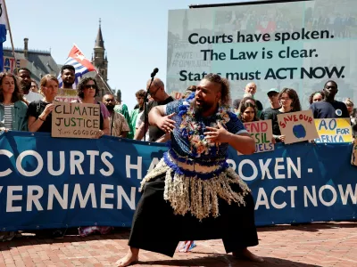 Climate activists and campaigners demonstrate outside the International Court of Justice (ICJ) ahead of the reading of an advisory opinion that is likely to determine the course of future climate action across the world, The Hague, Netherlands, July 23, 2025. REUTERS/Marta Fiorin