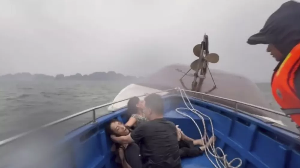 This image from a video provided by QDND shows people on a rescue boat after their tourist boat capsized in Ha Long Bay, Vietnam on Saturday, July 19, 2025. (QDND via AP)